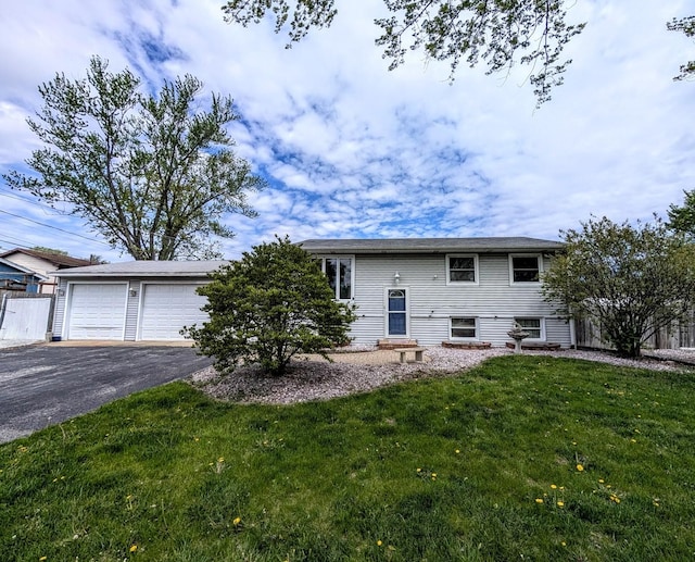 view of front facade with driveway, a front lawn, and an attached garage