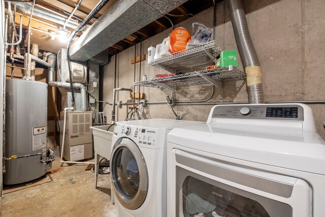 washroom with water heater, separate washer and dryer, and heating unit