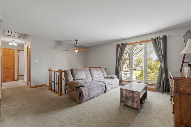 carpeted living room featuring attic access