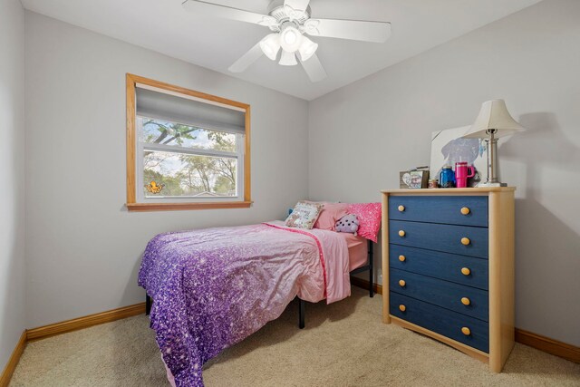 carpeted bedroom featuring baseboards and ceiling fan