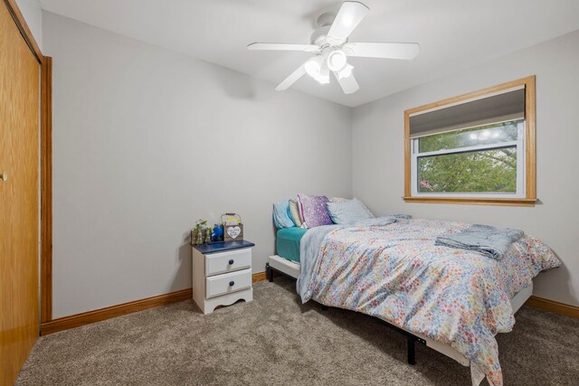 bedroom with carpet floors, a closet, baseboards, and a ceiling fan