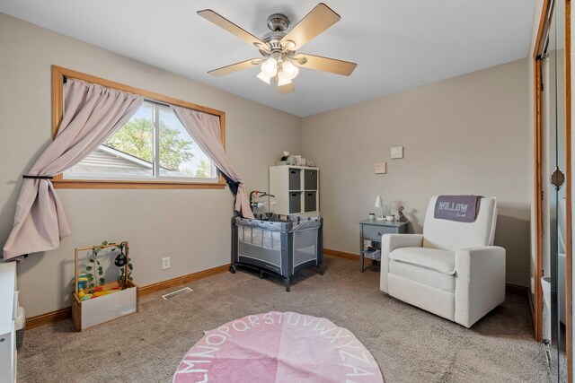 carpeted bedroom with baseboards and a ceiling fan