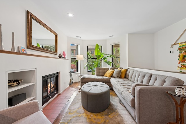 921 W Gunnison St Unit 1W, Chicago, IL 60640 - living room with recessed lighting, a glass covered fireplace, built in shelves, and baseboards