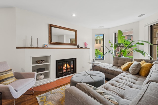 921 W Gunnison St Unit 1W, Chicago, IL 60640 - living room with built in features, recessed lighting, a glass covered fireplace, and tile patterned flooring