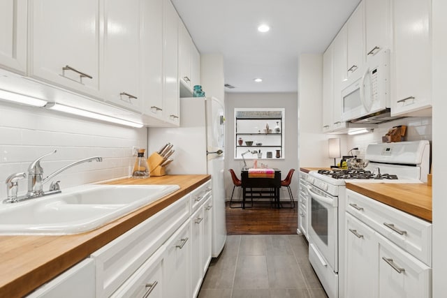 921 W Gunnison St Unit 1W, Chicago, IL 60640 - kitchen with butcher block counters, white appliances, a sink, tasteful backsplash, and recessed lighting