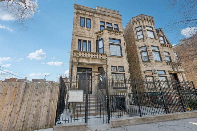 443 E 45th Pl Unit 3, Chicago, IL 60653 - view of front of home with a fenced front yard and a gate