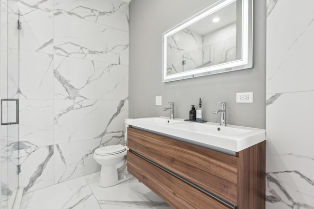 443 E 45th Pl Unit 3, Chicago, IL 60653 - full bath featuring marble finish floors, a marble finish shower, double vanity, and toilet