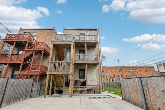 443 E 45th Pl Unit 3, Chicago, IL 60653 - rear view of house with stairway and a fenced backyard
