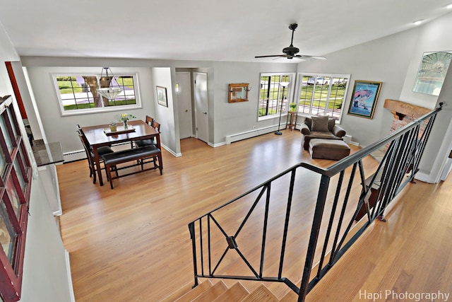 1129 Longmeadow Dr, Glenview, IL 60025 - living area with healthy amount of natural light, a baseboard radiator, ceiling fan, and baseboards
