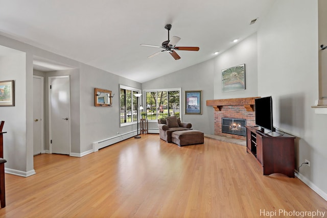 1129 Longmeadow Dr, Glenview, IL 60025 - living room featuring a ceiling fan, a brick fireplace, light wood finished floors, baseboard heating, and lofted ceiling