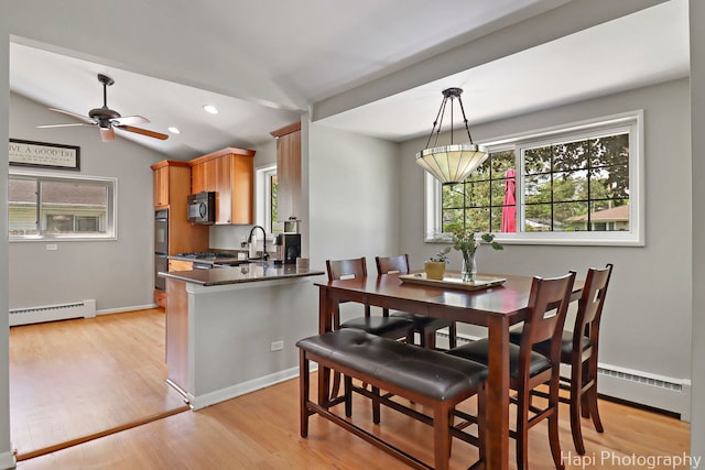 1129 Longmeadow Dr, Glenview, IL 60025 - dining area with a baseboard radiator, plenty of natural light, a ceiling fan, light wood-type flooring, and vaulted ceiling