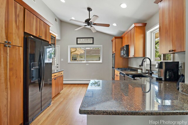 1129 Longmeadow Dr, Glenview, IL 60025 - kitchen featuring black appliances, a sink, a baseboard radiator, brown cabinets, and vaulted ceiling