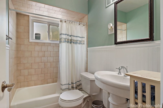 1129 Longmeadow Dr, Glenview, IL 60025 - bathroom with toilet, shower / bath combo with shower curtain, and a wainscoted wall