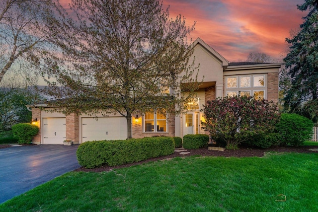 14460 Post Oak Ct, Green Oaks, IL 60048 - view of front of property with asphalt driveway, an attached garage, a front lawn, and brick siding