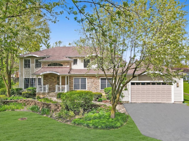2020 Techny Rd, Northbrook, IL 60062 - view of front of home with an attached garage, driveway, a front yard, and stone siding
