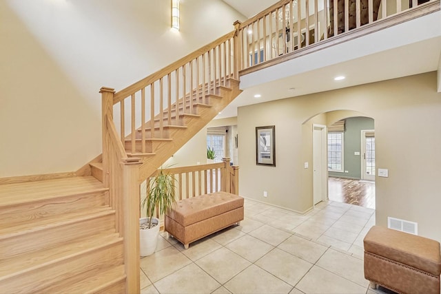 2020 Techny Rd, Northbrook, IL 60062 - stairway featuring tile patterned flooring, a wealth of natural light, arched walkways, and visible vents