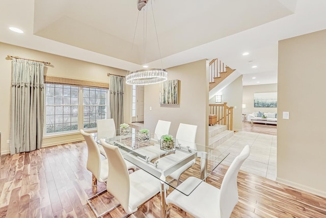 2020 Techny Rd, Northbrook, IL 60062 - dining room featuring a chandelier, stairs, light wood finished floors, and a raised ceiling