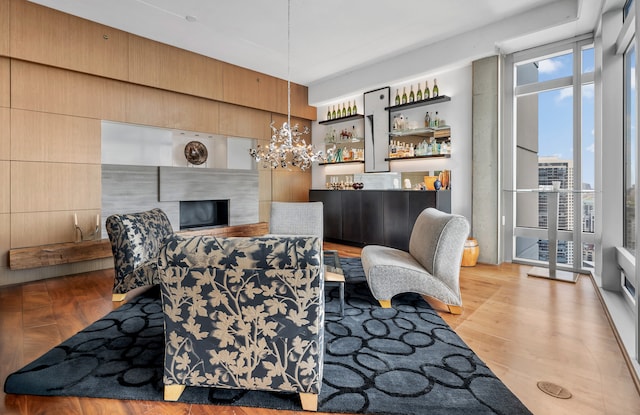 333 N Canal St Unit 3401, Chicago, IL 60606 - living room with wood finished floors, a fireplace, a bar, and a chandelier