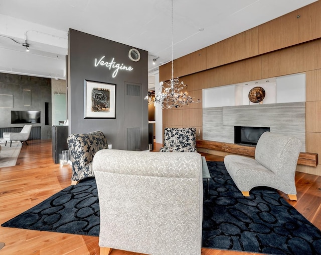 333 N Canal St Unit 3401, Chicago, IL 60606 - living room featuring a fireplace with raised hearth, wood finished floors, and track lighting