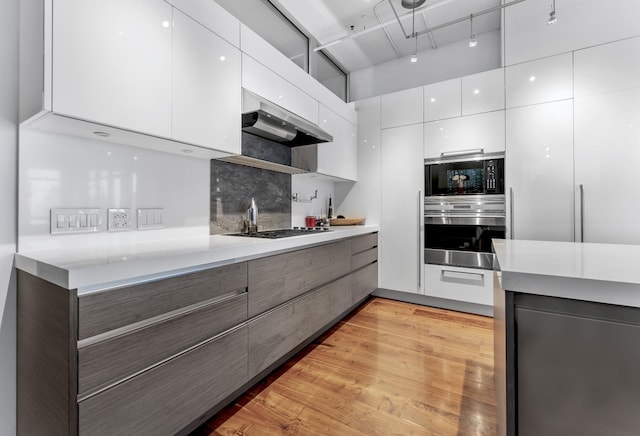 333 N Canal St Unit 3401, Chicago, IL 60606 - kitchen featuring stainless steel oven, modern cabinets, black microwave, and light countertops