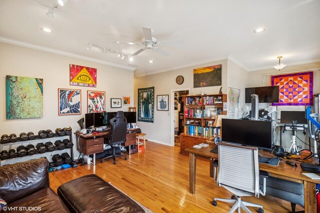 home office featuring a ceiling fan, crown molding, wood finished floors, rail lighting, and baseboards