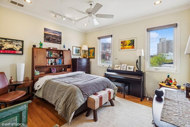 bedroom featuring crown molding, wood finished floors, recessed lighting, and a ceiling fan
