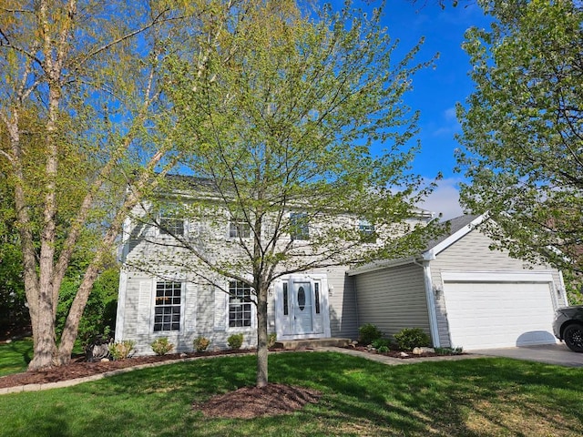 view of front of house with a front yard and a garage