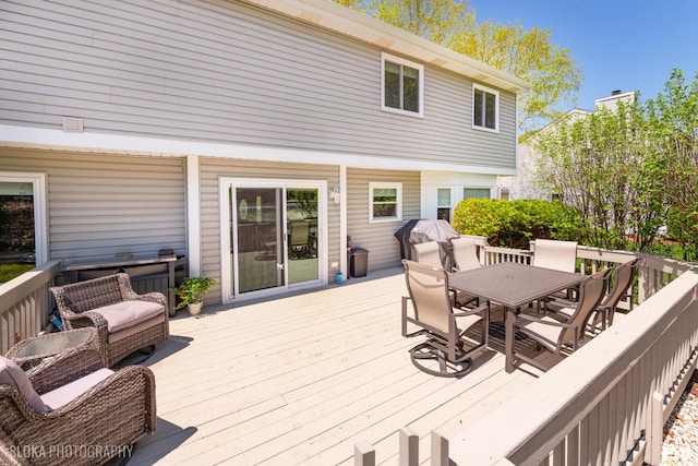 deck with outdoor dining area