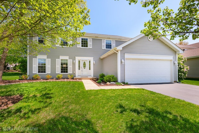 colonial inspired home with concrete driveway, a front lawn, and an attached garage