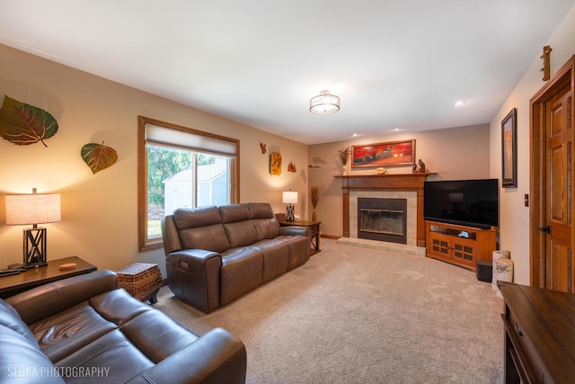 living room featuring a tile fireplace, light colored carpet, and recessed lighting