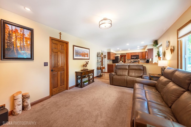 living room with light carpet, recessed lighting, and baseboards