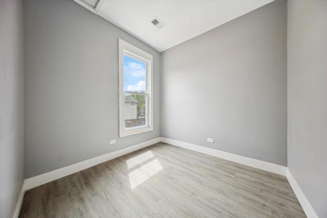 spare room with wood finished floors and baseboards