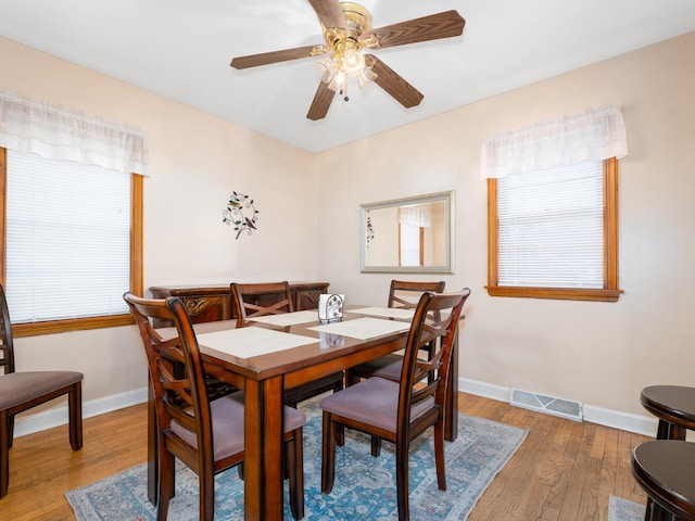 2504 W St, River Grove, IL 60171 - dining area with baseboards, wood-type flooring, and a ceiling fan