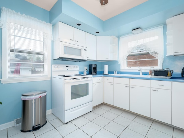 2504 W St, River Grove, IL 60171 - kitchen featuring white appliances, white cabinets, and light tile patterned floors