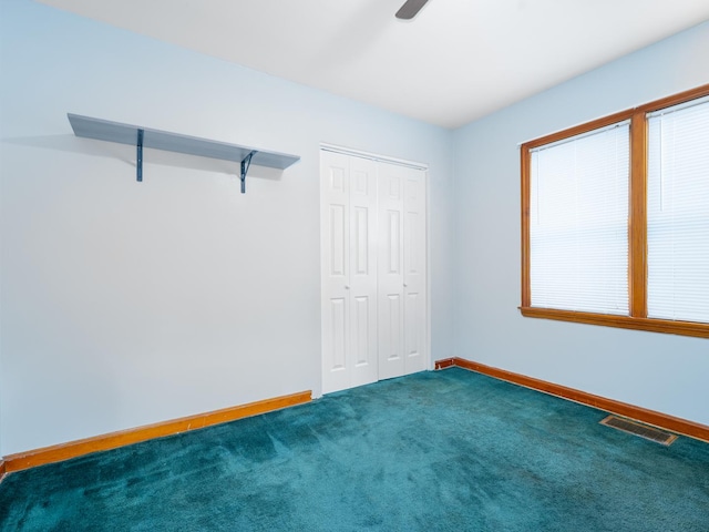 2504 W St, River Grove, IL 60171 - unfurnished bedroom featuring baseboards, carpet floors, a closet, and a ceiling fan