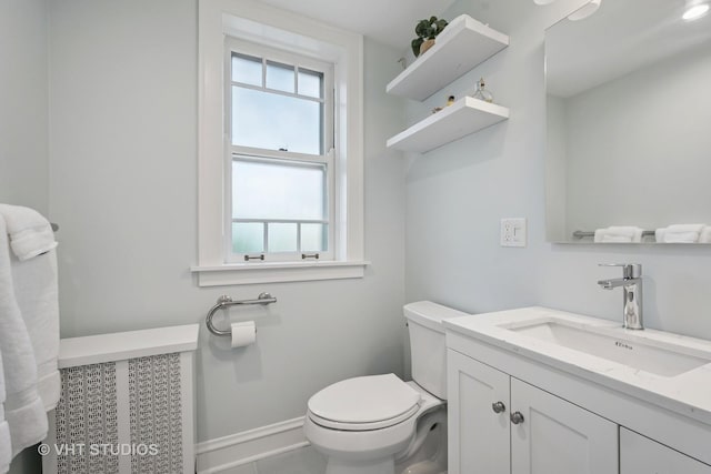 2472 W Estes Ave Unit 2, Chicago, IL 60645 - bathroom with toilet, baseboards, and vanity