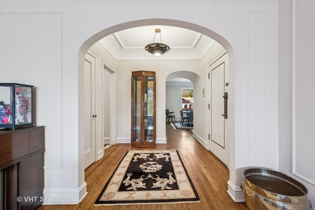 2472 W Estes Ave Unit 2, Chicago, IL 60645 - foyer entrance featuring arched walkways, light wood finished floors, and crown molding
