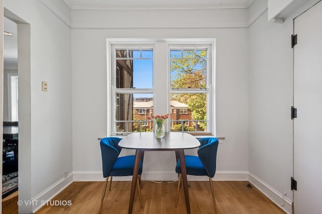2472 W Estes Ave Unit 2, Chicago, IL 60645 - dining space with wood finished floors, baseboards, plenty of natural light, and crown molding