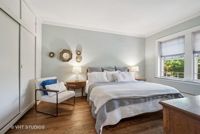 2472 W Estes Ave Unit 2, Chicago, IL 60645 - bedroom with crown molding, dark wood finished floors, baseboards, a closet, and a baseboard heating unit