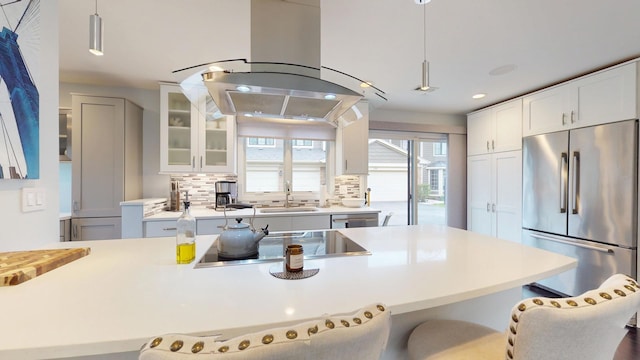 1322 Downs Pkwy, Libertyville, IL 60048 - kitchen featuring appliances with stainless steel finishes, a sink, island exhaust hood, a breakfast bar area, and glass insert cabinets