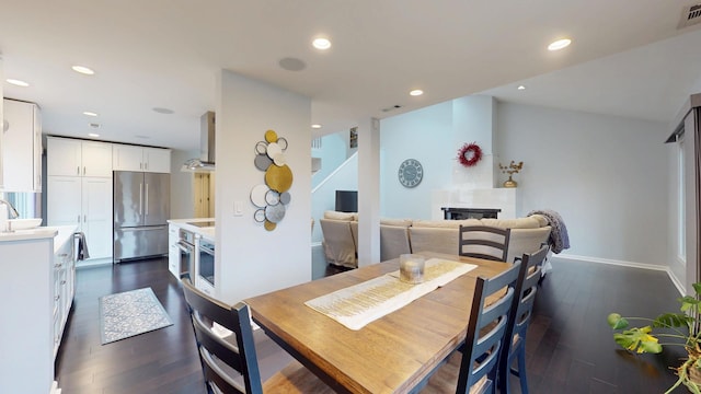 1322 Downs Pkwy, Libertyville, IL 60048 - dining area featuring dark wood-style floors, a fireplace, recessed lighting, and baseboards