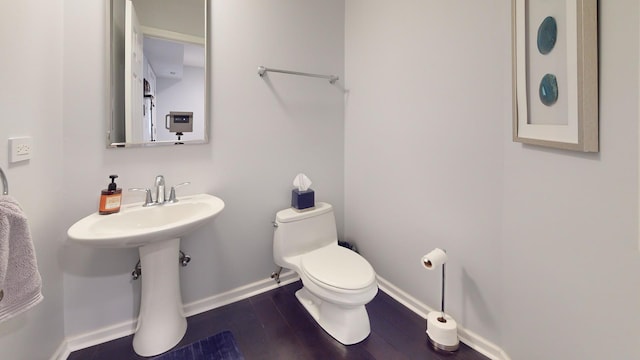 1322 Downs Pkwy, Libertyville, IL 60048 - half bathroom with baseboards, toilet, and wood finished floors