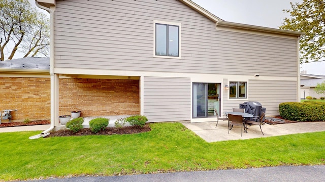 1322 Downs Pkwy, Libertyville, IL 60048 - rear view of house with a patio, a lawn, and brick siding