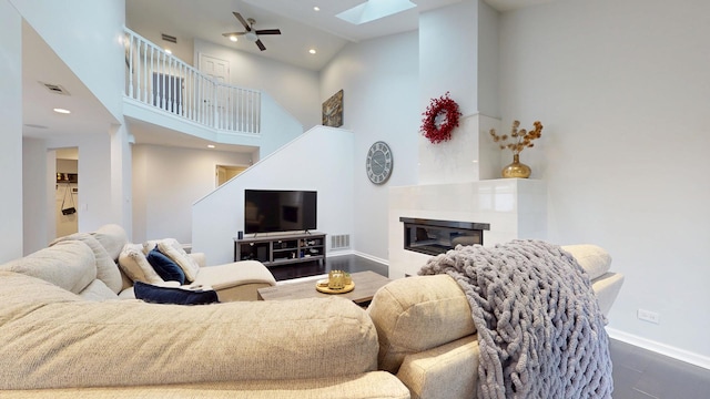 1322 Downs Pkwy, Libertyville, IL 60048 - living area with a skylight, baseboards, a high ceiling, recessed lighting, and a tiled fireplace