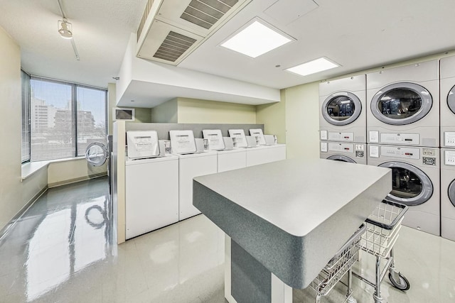 400 N Lasalle St Unit 2207, Chicago, IL 60654 - shared laundry featuring stacked washing machine and dryer, washer and clothes dryer, and light tile patterned floors