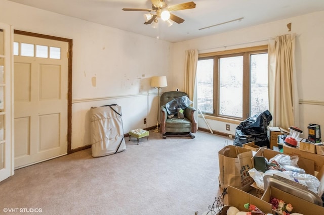 sitting room featuring carpet flooring, ceiling fan, and baseboards