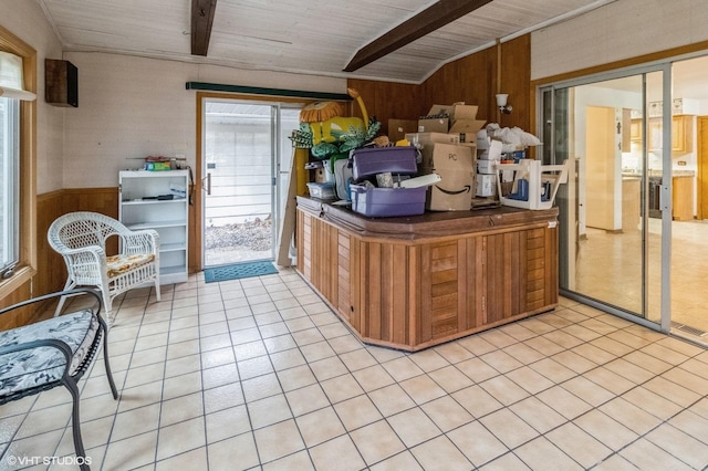 kitchen with wood walls and light tile patterned floors