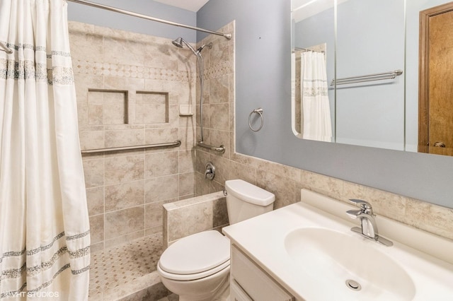 full bath with a tile shower, toilet, and vanity