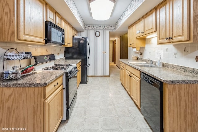 kitchen featuring black appliances, a sink, wallpapered walls, backsplash, and light flooring