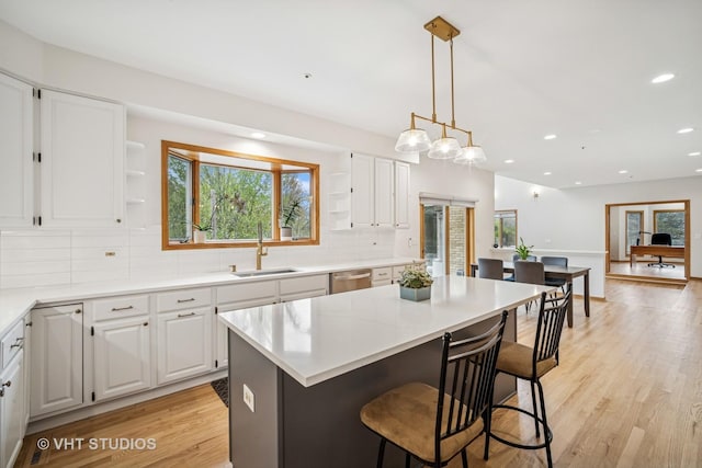 kitchen with open shelves, a sink, white cabinetry, and recessed lighting
